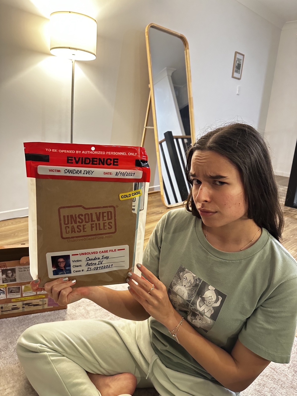 Ioana holding an Unsolved Case File mystery game